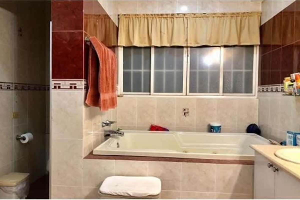 Bathroom with bathtub, beige-brown tiles in Betania duplex Panama City