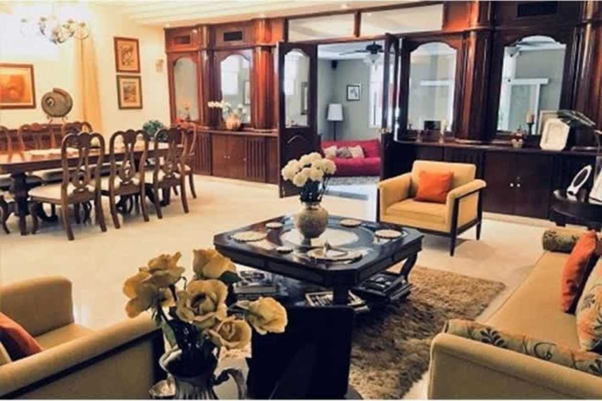 Living room with red sofa, work desk, large windows in duplex Betania Panama City