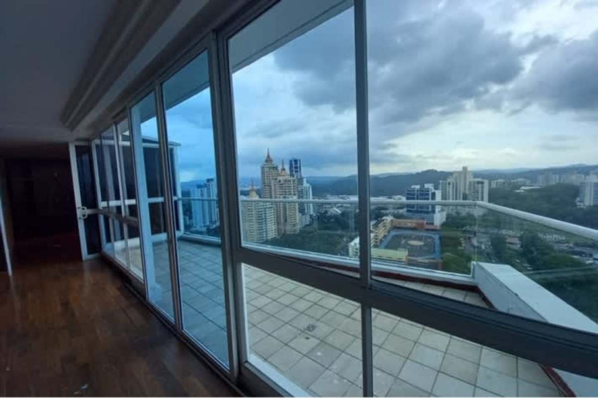 Bright master bedroom with large windows overlooking Panama City in The Forum El Cangrejo