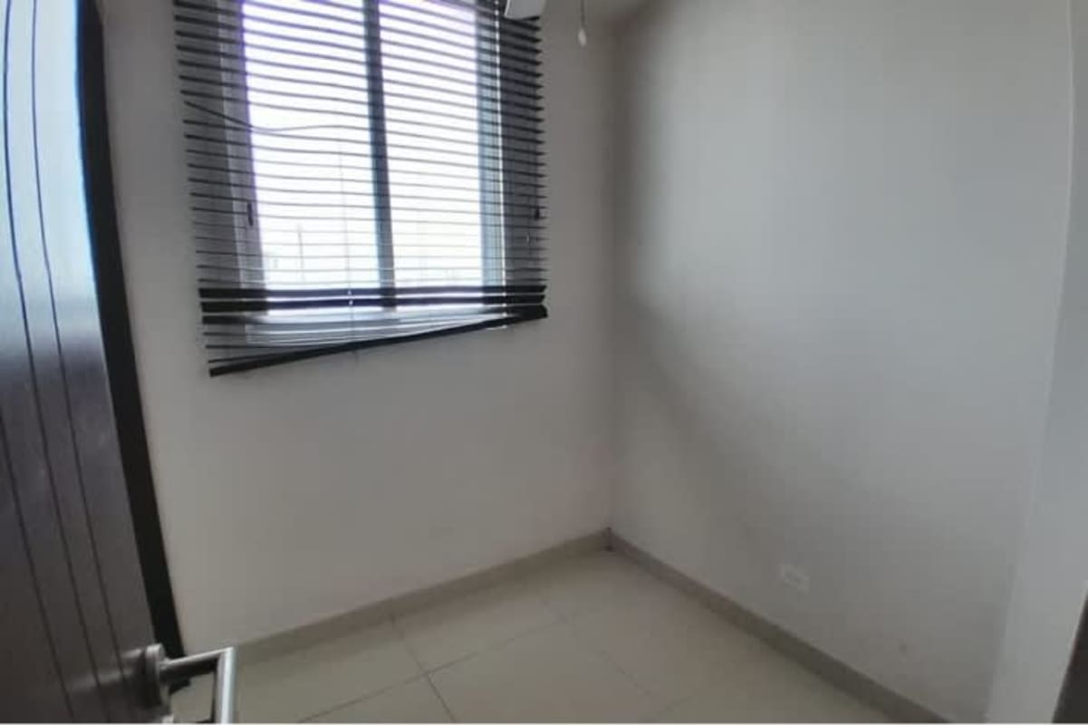 Spacious living room with access to large balcony overlooking cityscape at PH Mirador La Loma Panama City