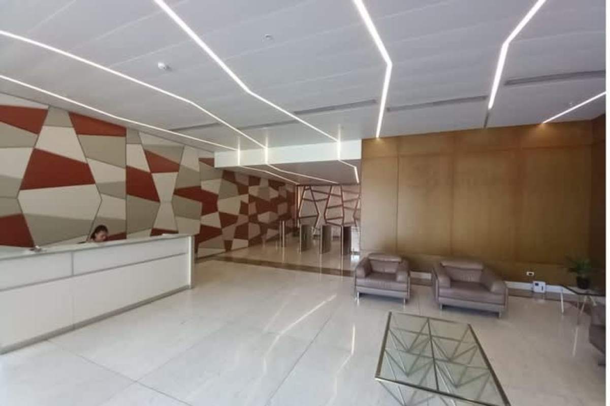 Contemporary commercial lobby with reception, sofa set and illuminated ceiling PH Atrium Tower Obarrio
