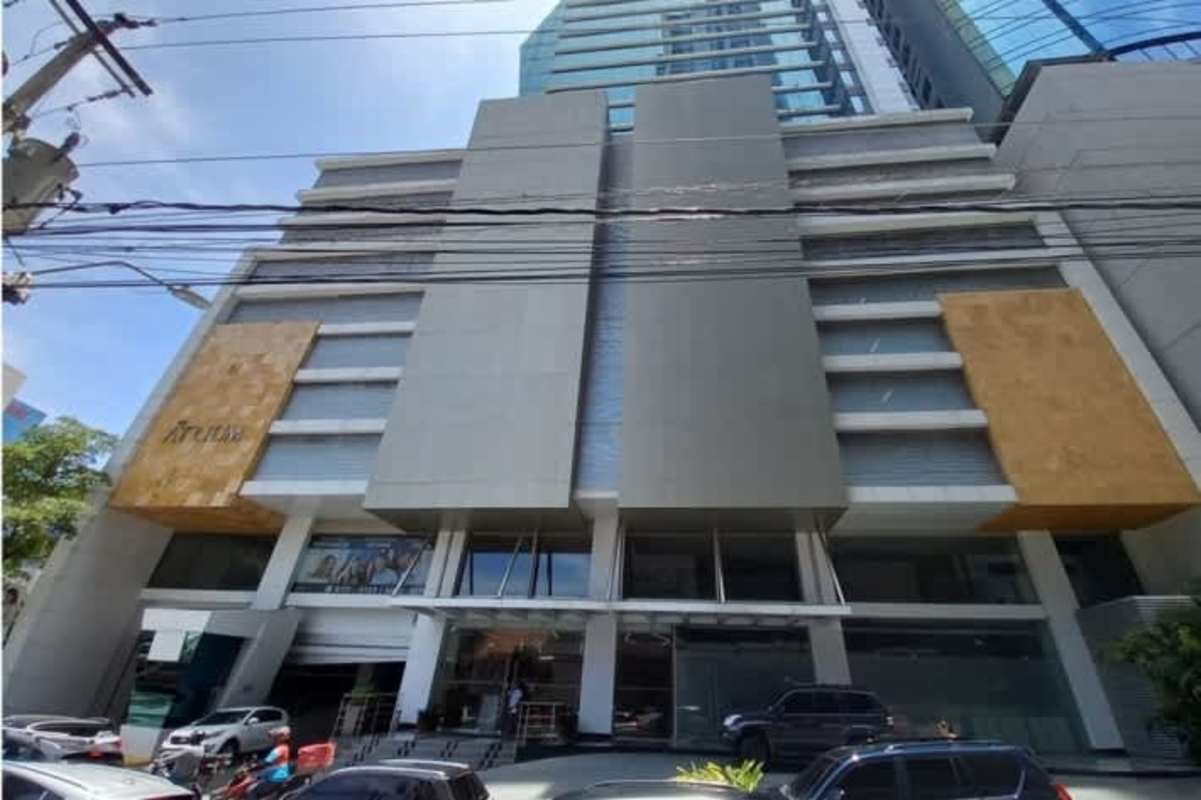 Modern multi-story commercial building PH Atrium Tower with glass facade and parking in Obarrio Panama
