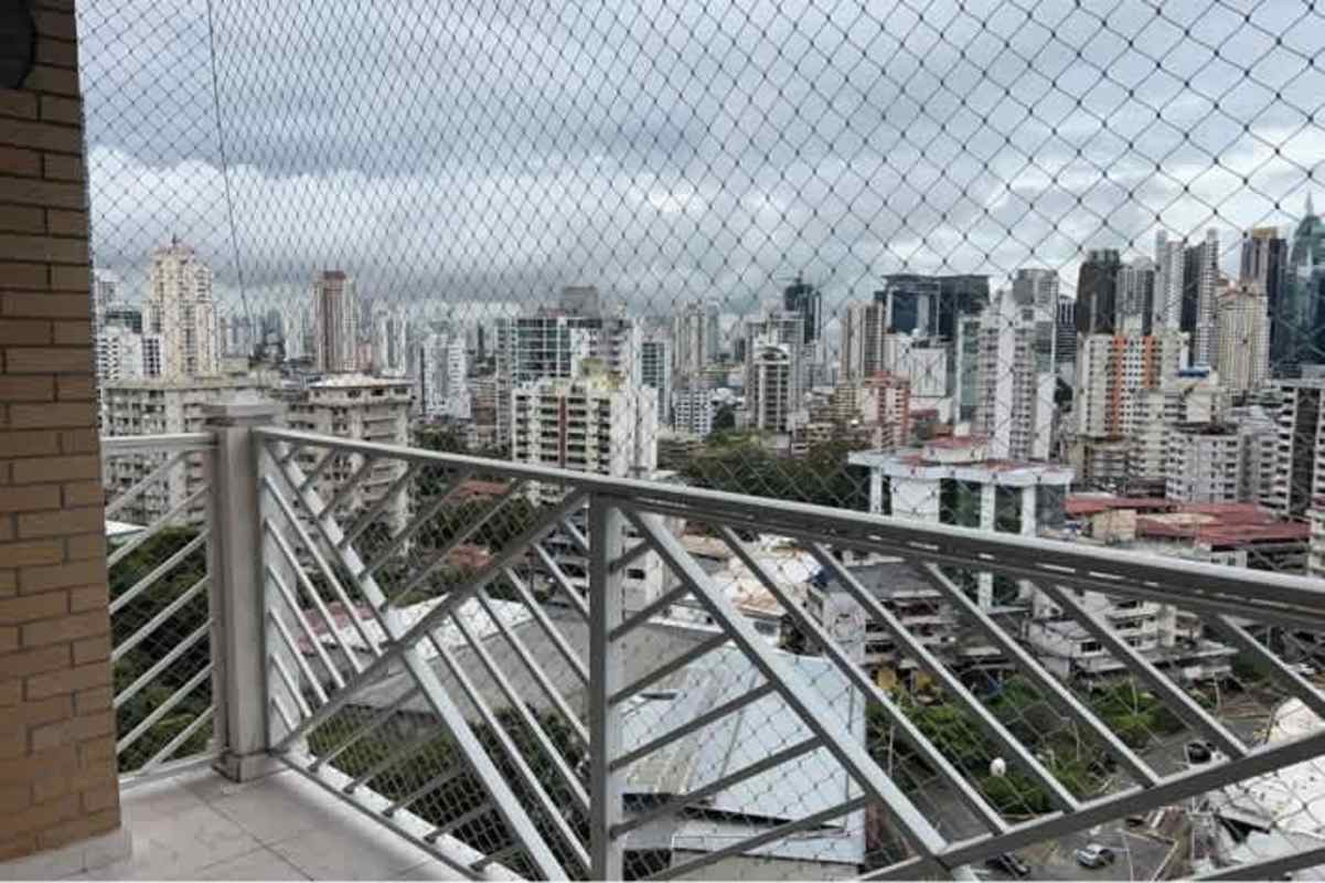 High-rise balcony with skyline view and safety netting from PH El Cangrejo apartment Panama City