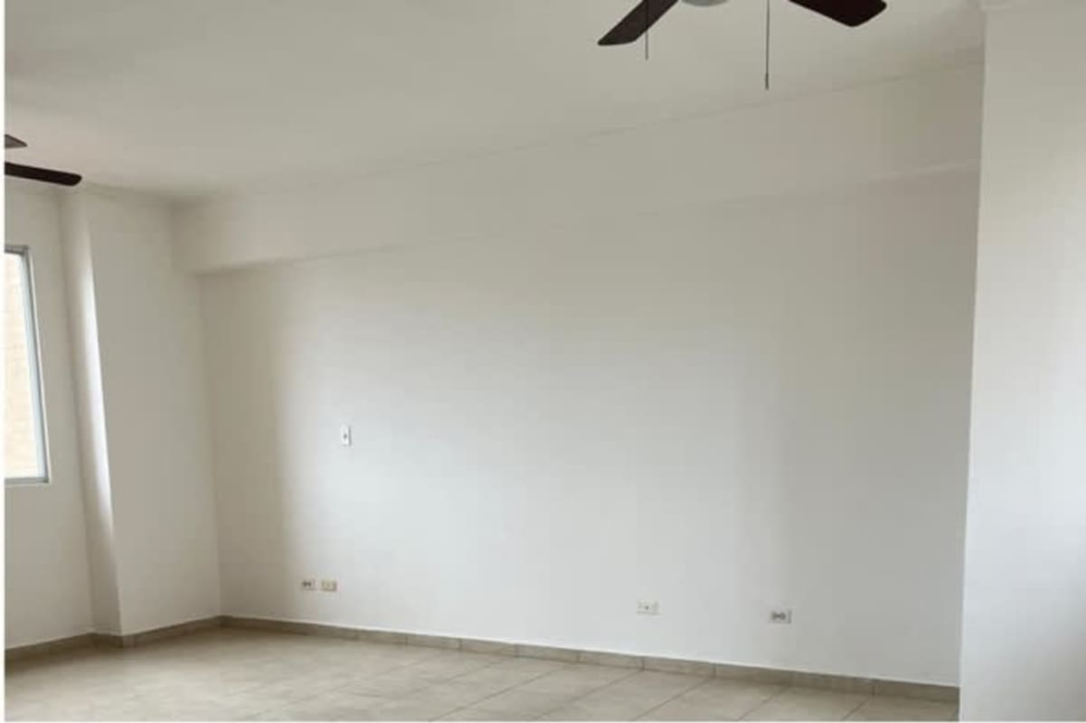 Spacious bedroom with tile flooring, large window at PH El Cangrejo apartment Panama