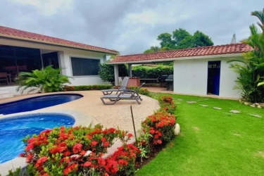 Covered terrace with outdoor dining overlooking pool garden villa Coronado Panama