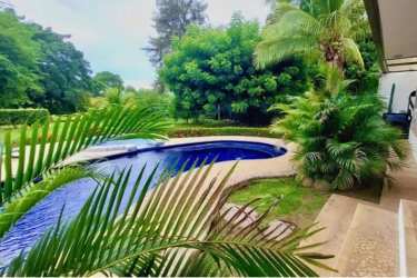 Backyard pool, patio and lush gardens golf villa Coronado Panama for sale