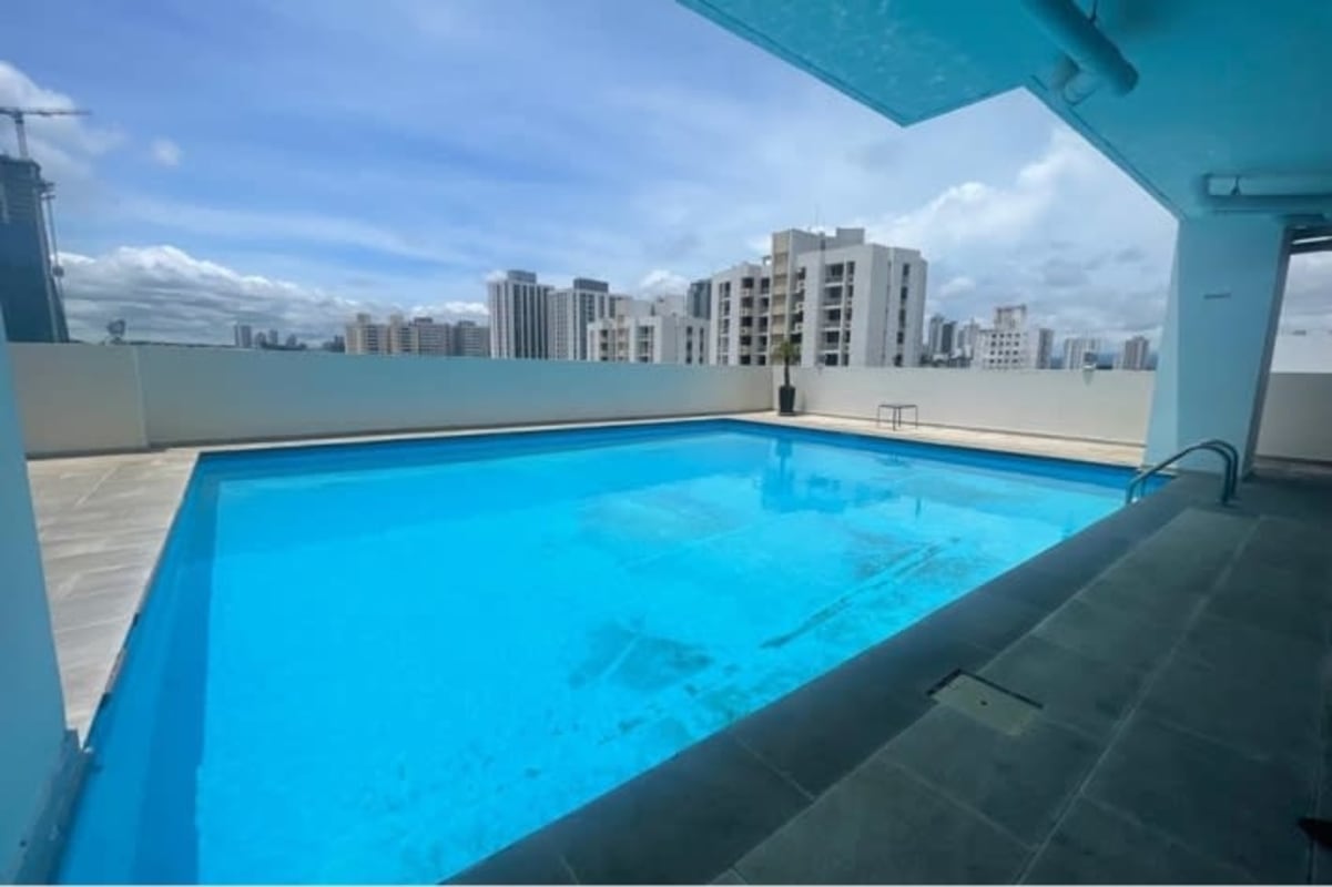 Rooftop swimming pool with clear water, city skyline view at PH Vía España Panama City for rent residents