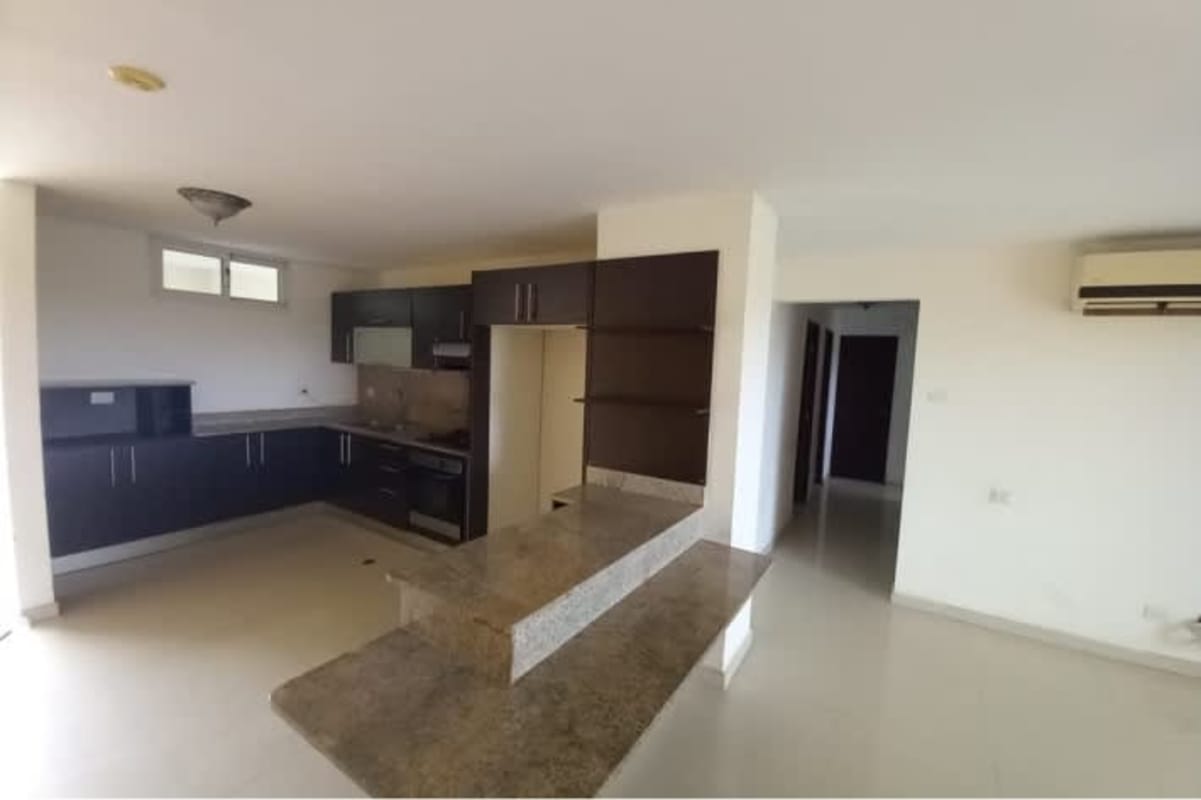 Kitchen with granite countertops and dark cabinets in PH Altamira Gardens Ancon Panama