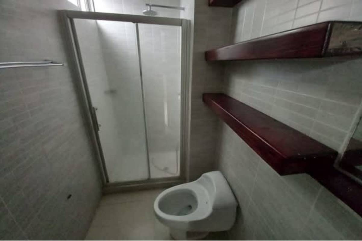 Modern bathroom with glass shower enclosure and cabinet storage PH Altamira Gardens Panama City