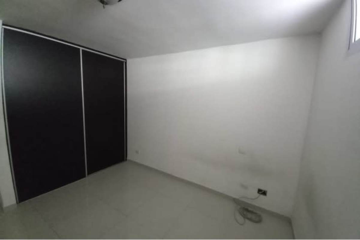 Minimalist bedroom with black built-in wardrobe sliding doors PH Altamira Gardens Panama
