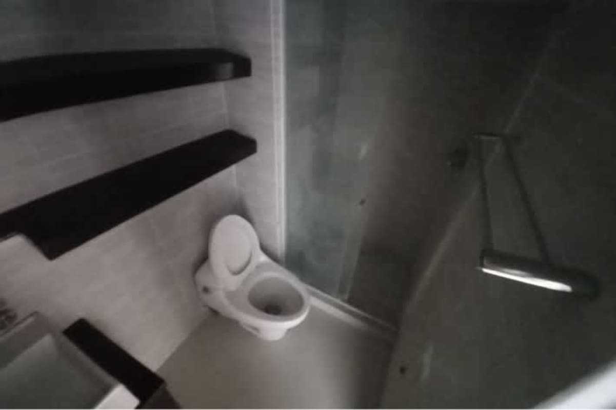 Modern minimalist bathroom, glass shower enclosure, floating shelves PH Altamira Gardens Panama