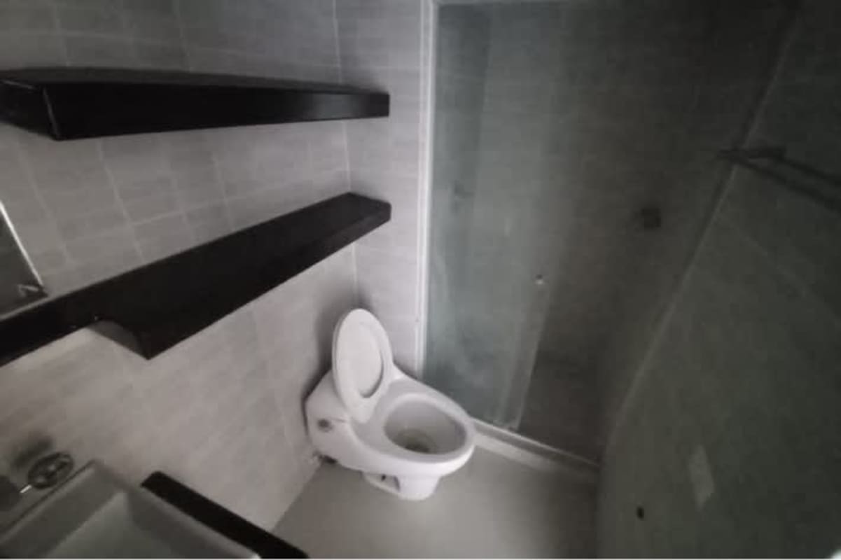 Bathroom with gray tiles, glass shower, floating shelves in PH Altamira Gardens Panama