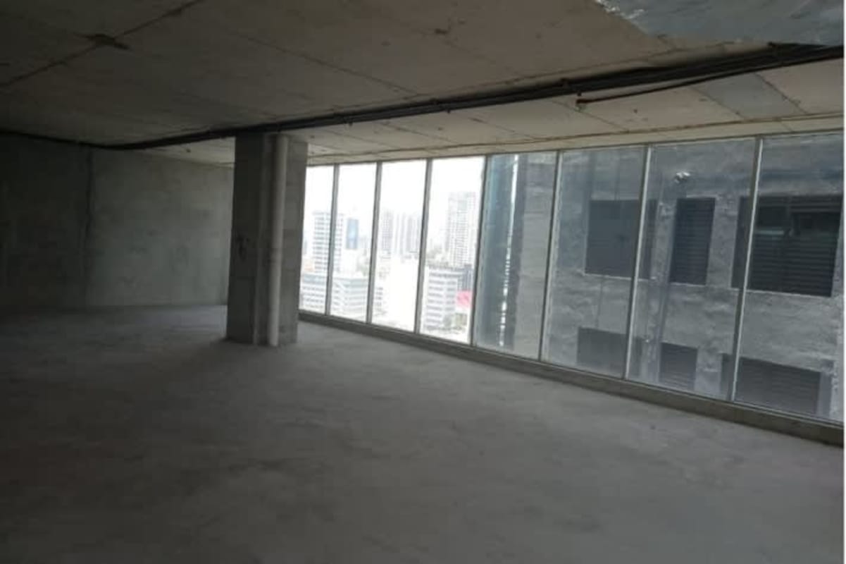 Unfinished office space with concrete walls, glass entry and skyline view in Atrium Tower Panama