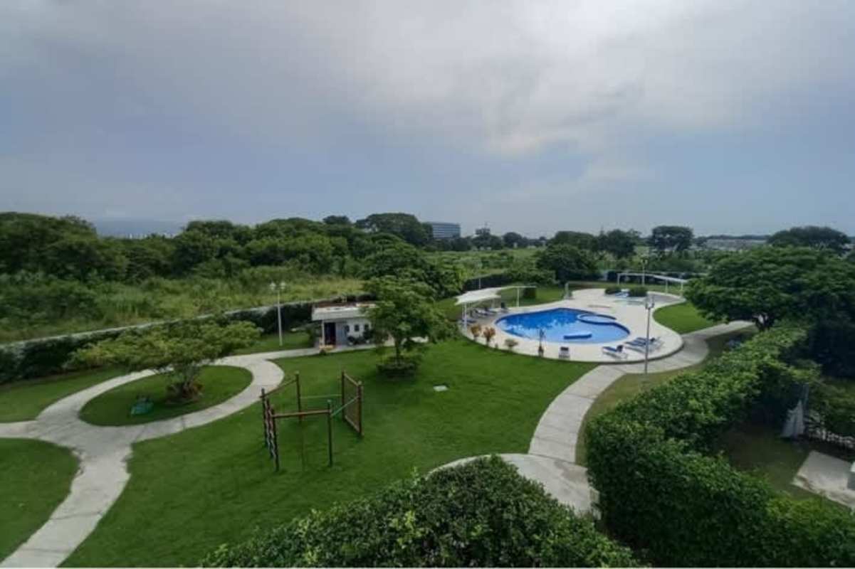 Spacious living dining room with open kitchen and sliding glass doors Costa Sur Village