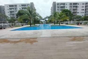 Resort-style swimming pool surrounded by palm trees at PH Midrise Panama Pacifico