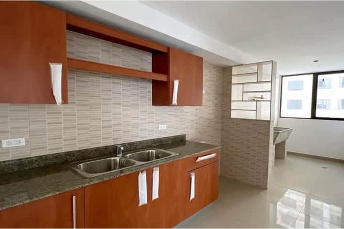 Spacious kitchen with wooden cabinetry, granite countertops, tiled backsplash PH San Francisco Bay Panama City