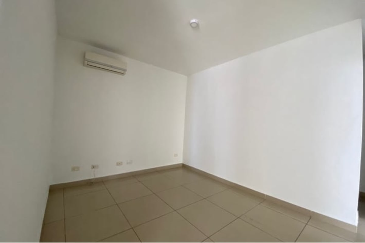 Empty bedroom with AC unit, tile floor, white walls PH San Francisco Bay Panama