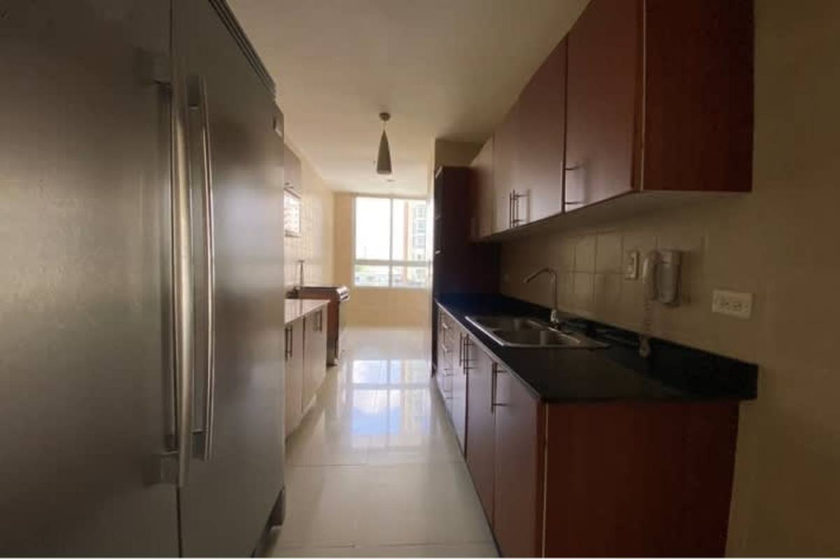 Kitchen with granite counters, wood cabinets, natural light in PH San Francisco Bay Panama City