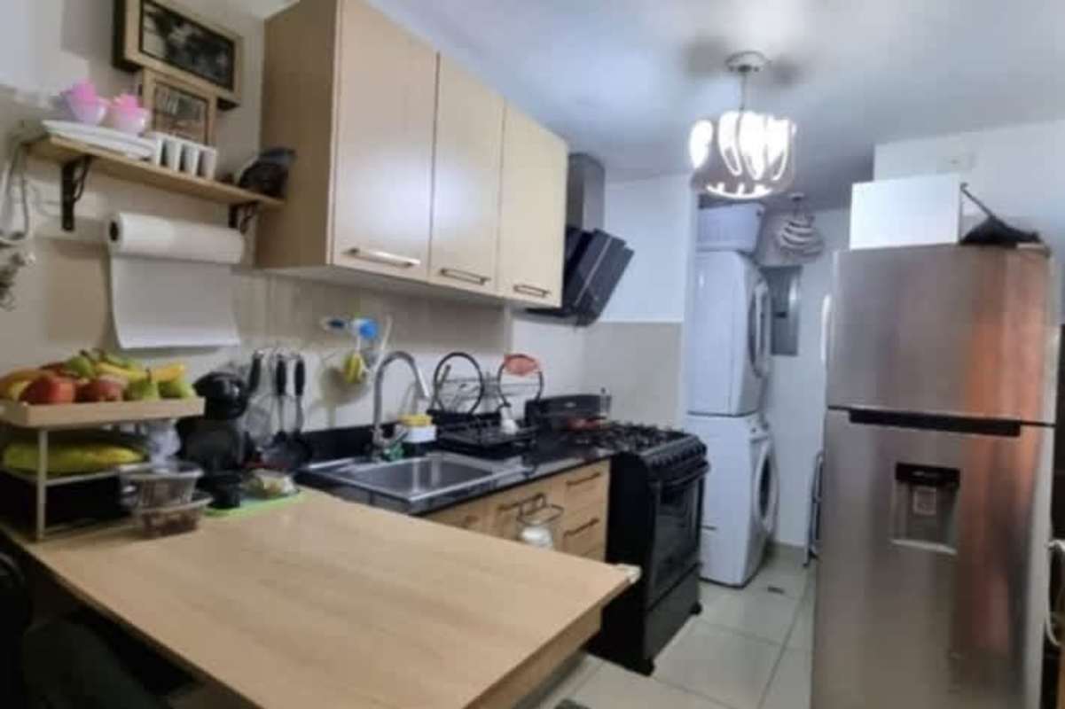 Kitchen with appliances and integrated laundry at PH Torres de Castilla Panama City