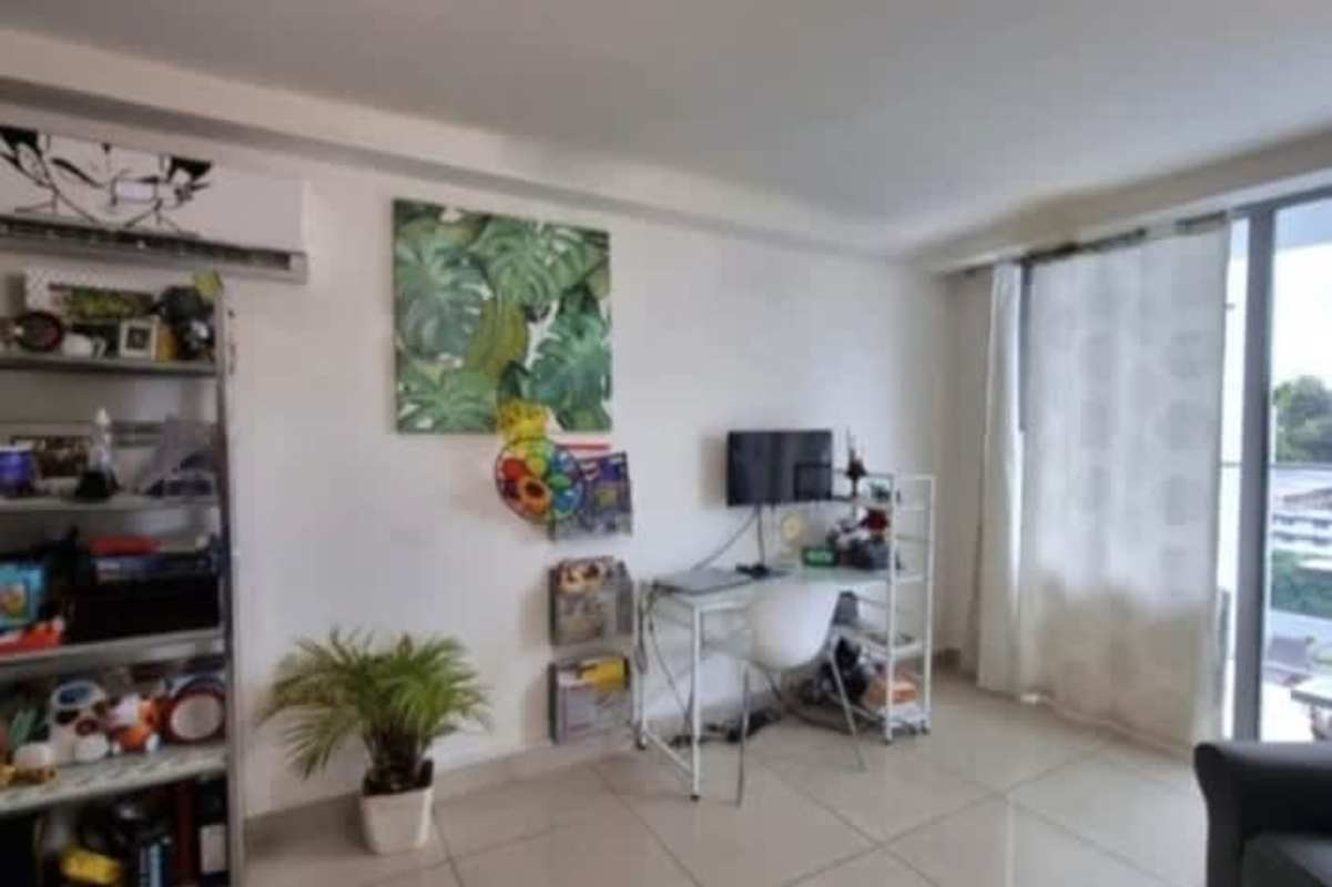 Living room with workspace corner and balcony access PH Torres de Castilla Panama City