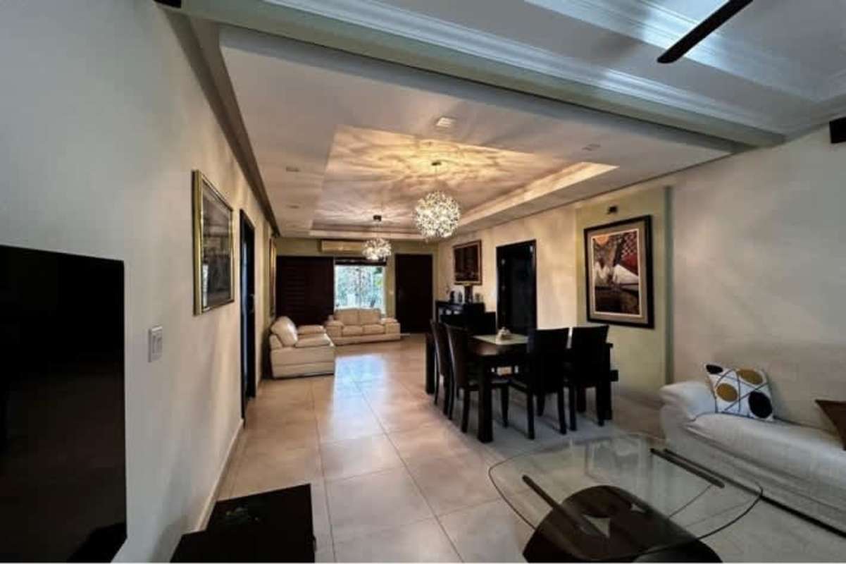 Open plan living and dining with pendant lights tile floor in Betania house for sale Panama