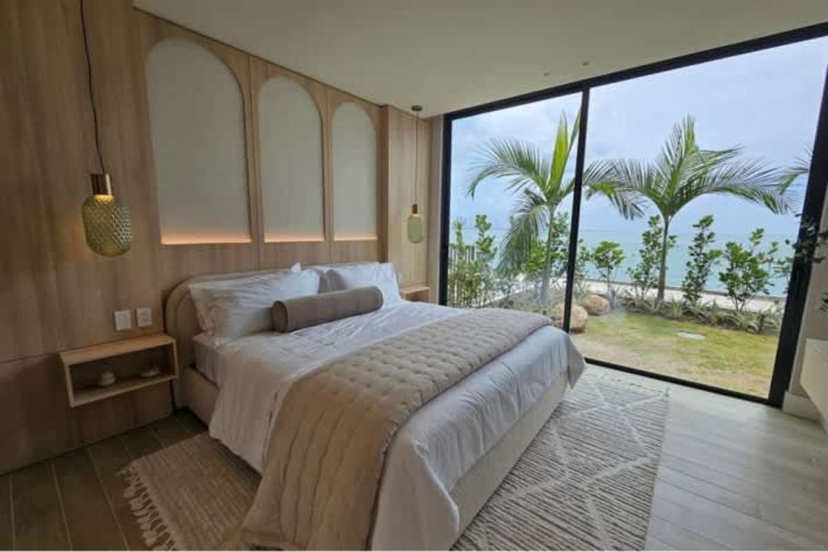 Master bedroom with floor-to-ceiling windows featuring Pacific Ocean views at Ocean Reef Panama