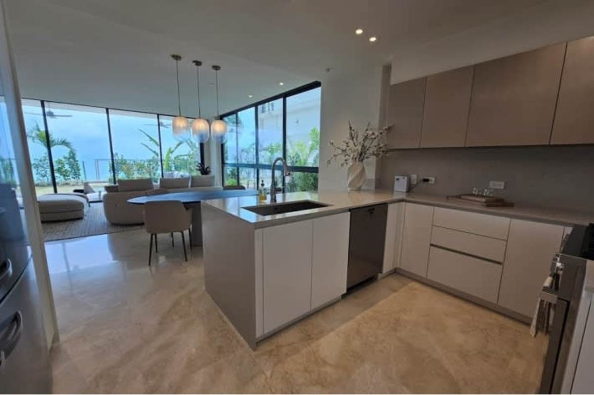 Luxury kitchen with island, sleek cabinetry and ocean view in Ocean Reef Marina Residences Panama