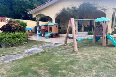 Spacious garden with children's playground and patio in Coronado beach villa