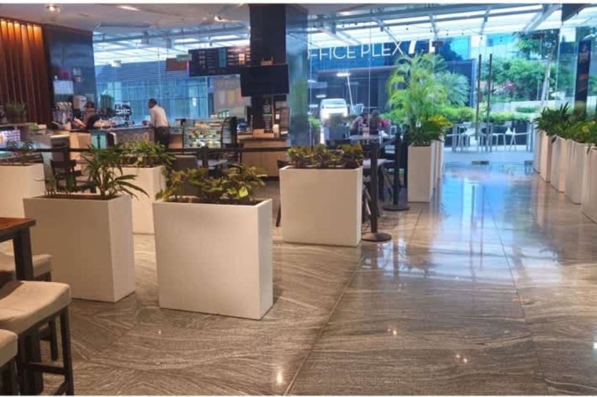 Elevator hall with wood panels, marble floors and multiple elevators at Santa Maria Business District Panama