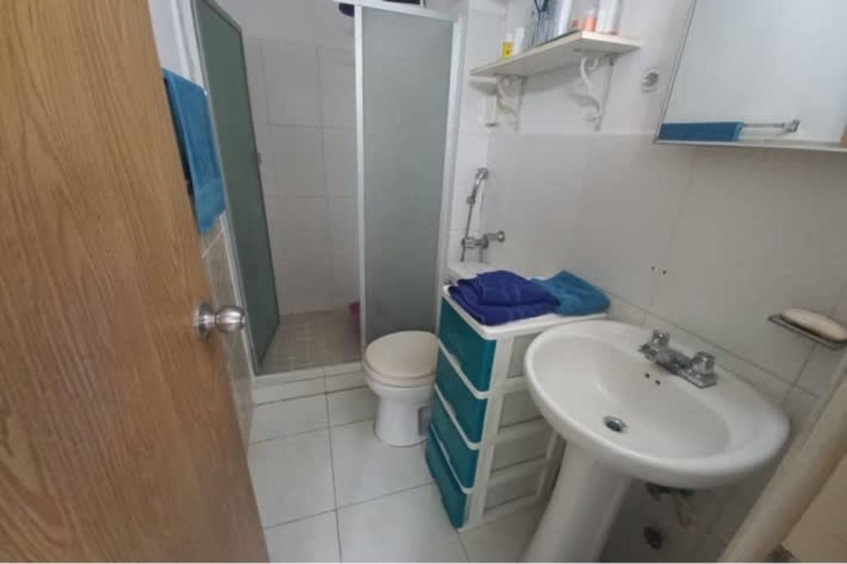 Multi-story apartment building with balconies and parking spaces Llano Bonito Panama