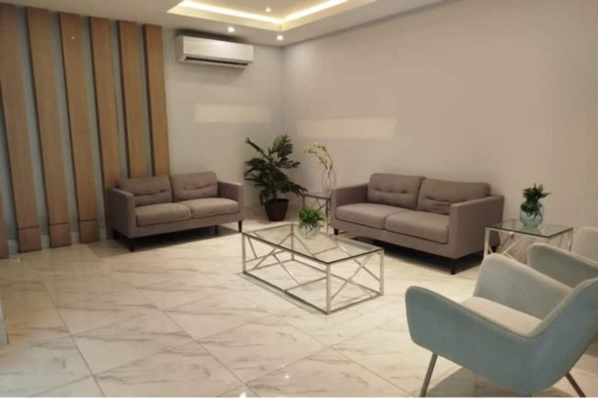 Contemporary kitchen with granite countertop and light wood cabinets in PH Carrasquilla Residence Panama City