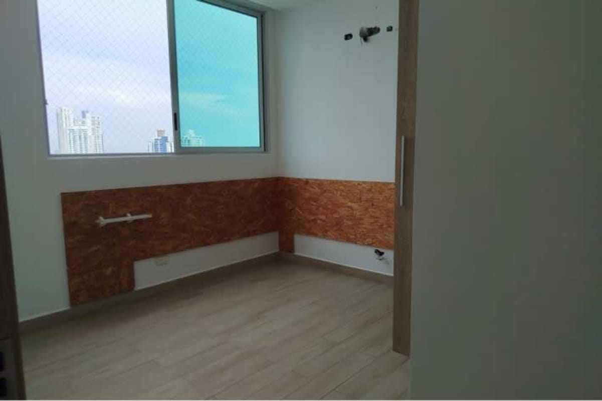 Main bedroom with built-in closet and skyline view window PH San Francisco Tower Panama City