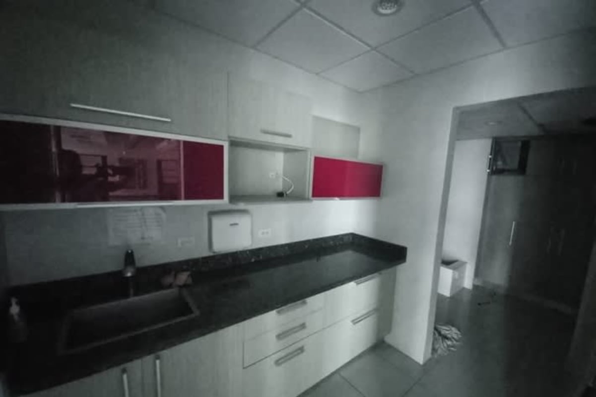Compact kitchenette with granite countertop and red accent cabinets PH Office One Panama