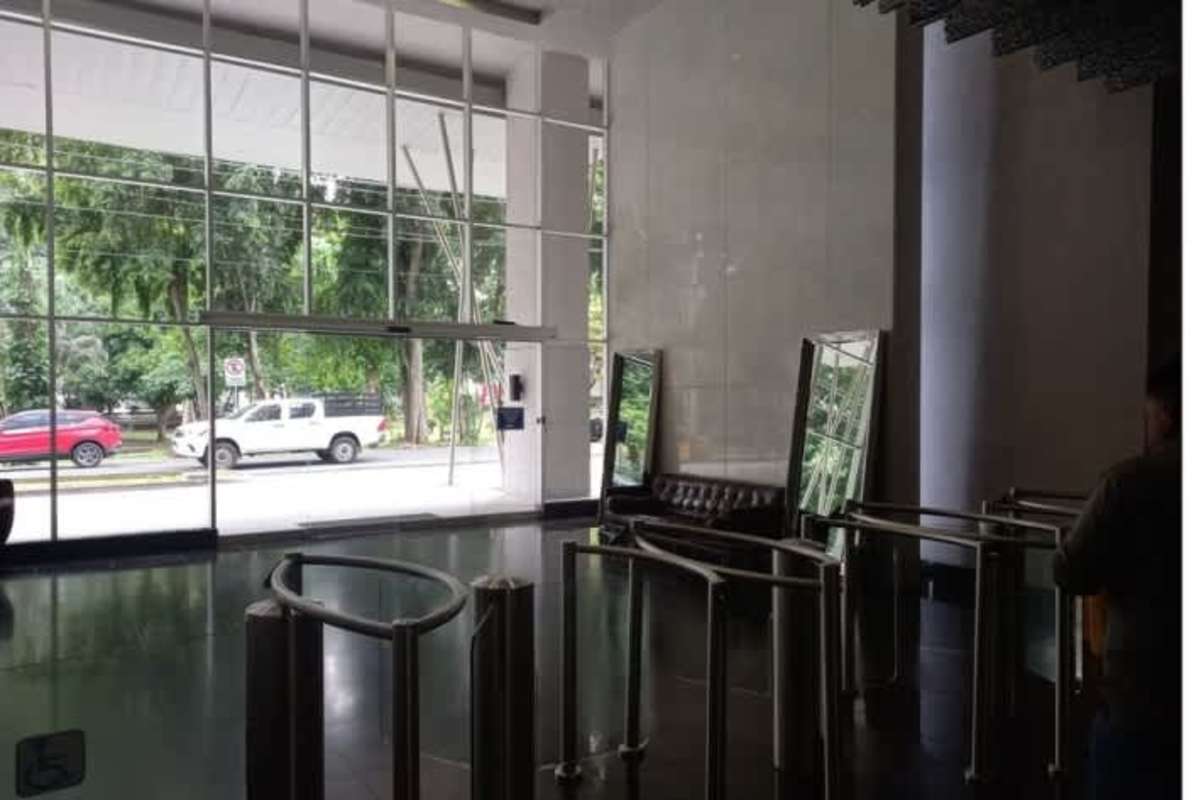 Modern lobby with security turnstiles and black sofa PH Office One Obarrio Panama
