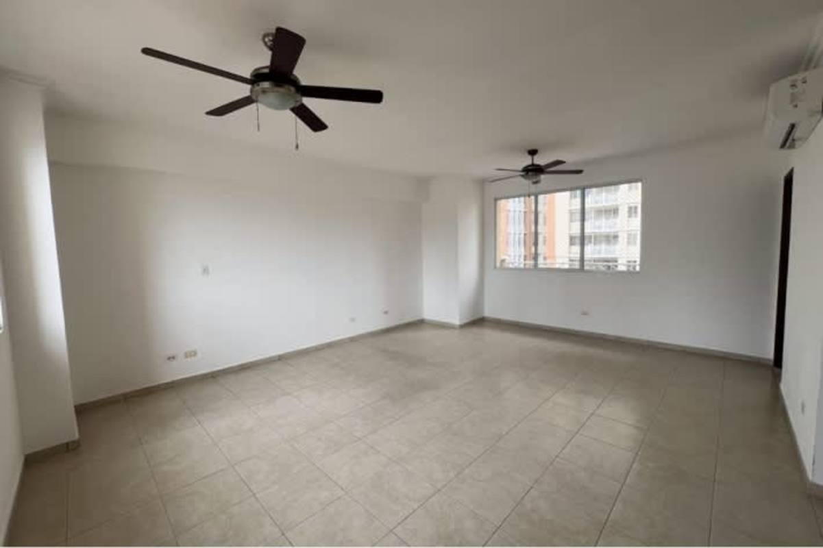 Living room with ceramic tiles, fans, large windows city skyline at PH Vista Nova El Cangrejo Panama