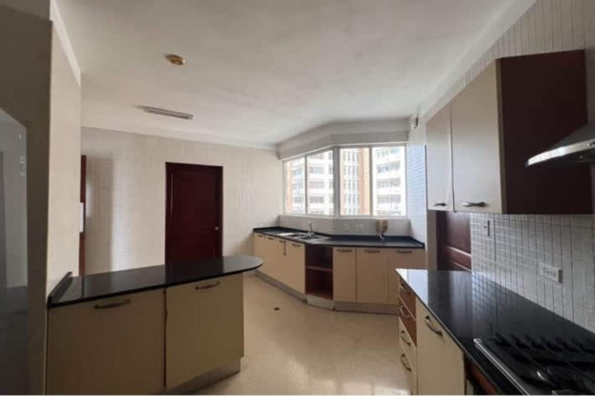Kitchen with granite countertops, bay window views, wooden cabinets at PH Vista Nova Panama