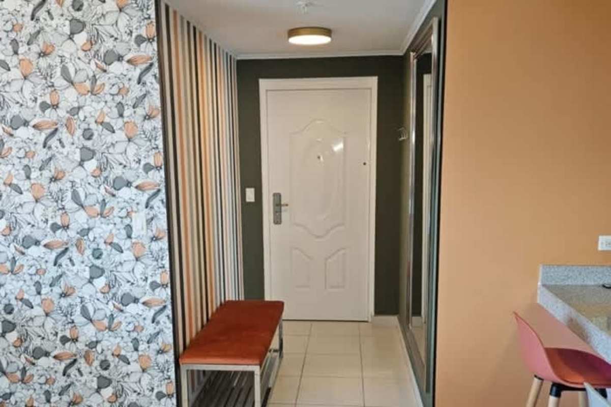 Eclectic hallway with floral and striped wallpaper in PH Miró El Cangrejo Panama