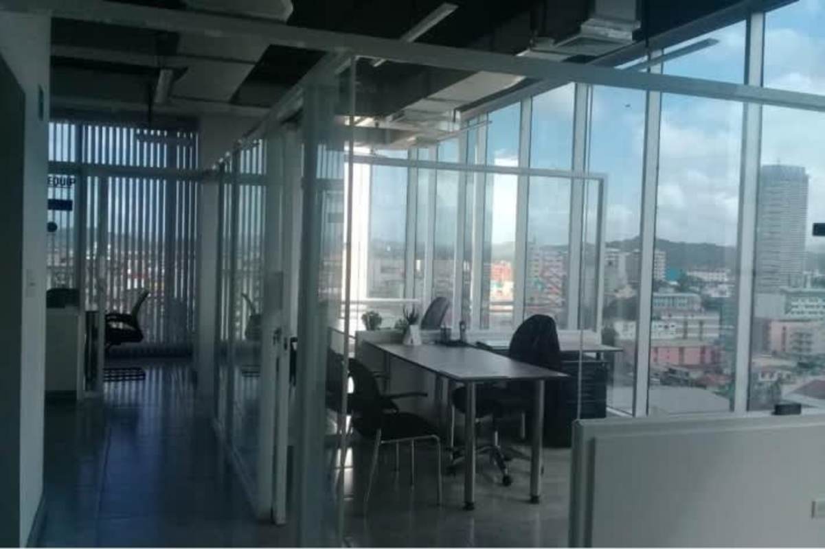 Modern office space with workstations, glass walls, panoramic city view PH Balboa Office Center Panama