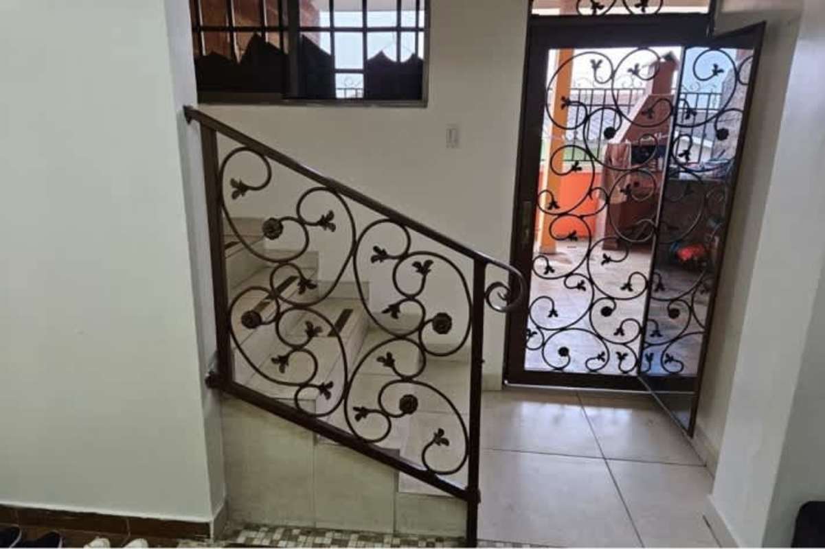 Entryway staircase with wrought iron decor and security door leading to patio in Altos de Las Praderas San Antonio Panama