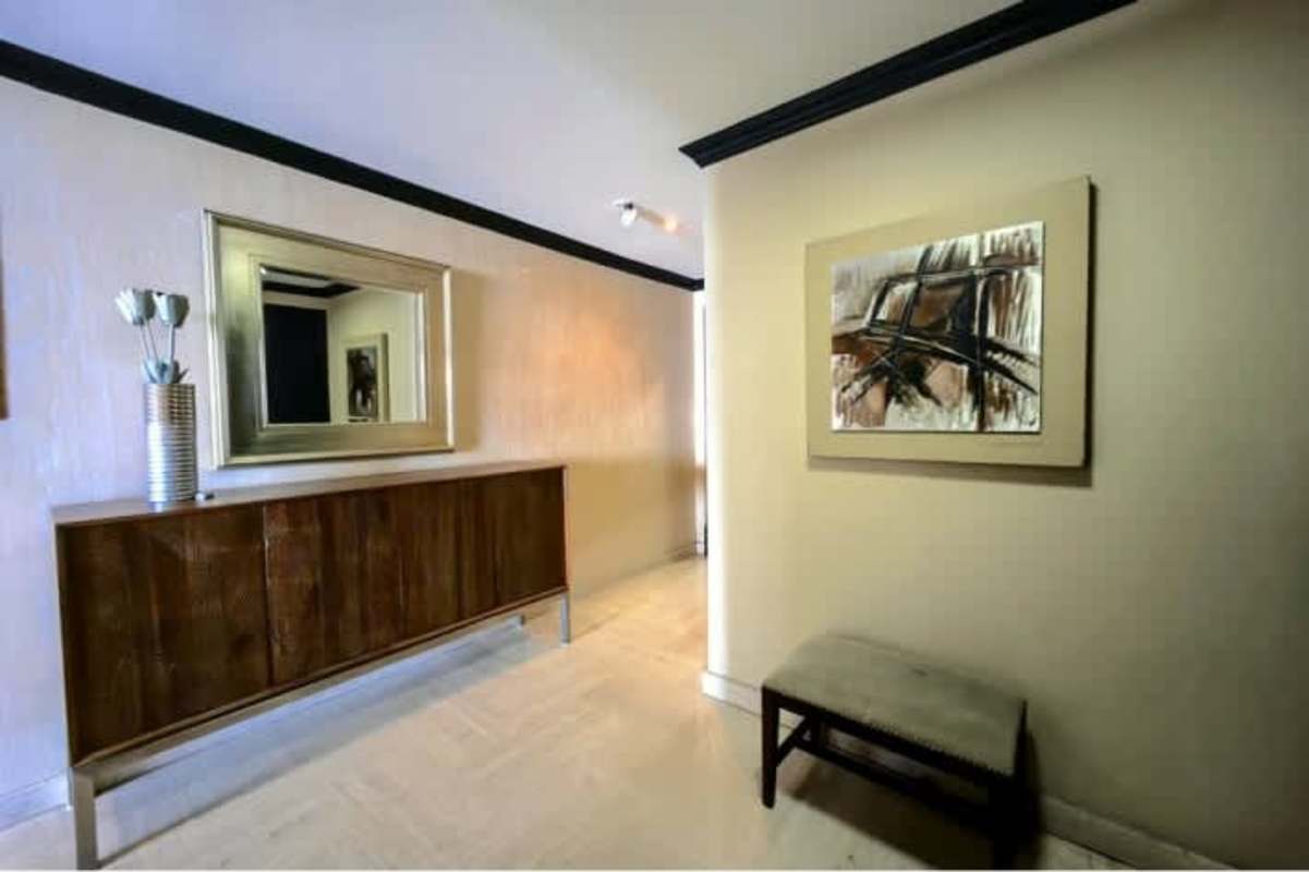 Master bedroom with large window, city and ocean view at PH BICSA Tower Panama City