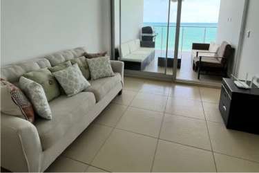 Bright living room with access to balcony, ocean views, and modern furnishings at PH Royal Palm