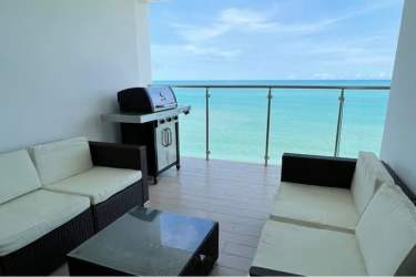Modern oceanview balcony with outdoor BBQ grill and seating at PH Royal Palm San Carlos