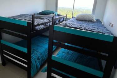 Guest bedroom with bunk beds and large window with ocean or mountain views at PH Royal Palm