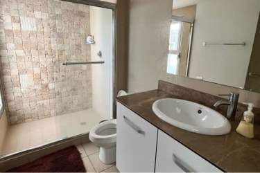 Contemporary bathroom with glass shower enclosure and single vanity in PH Royal Palm Panama
