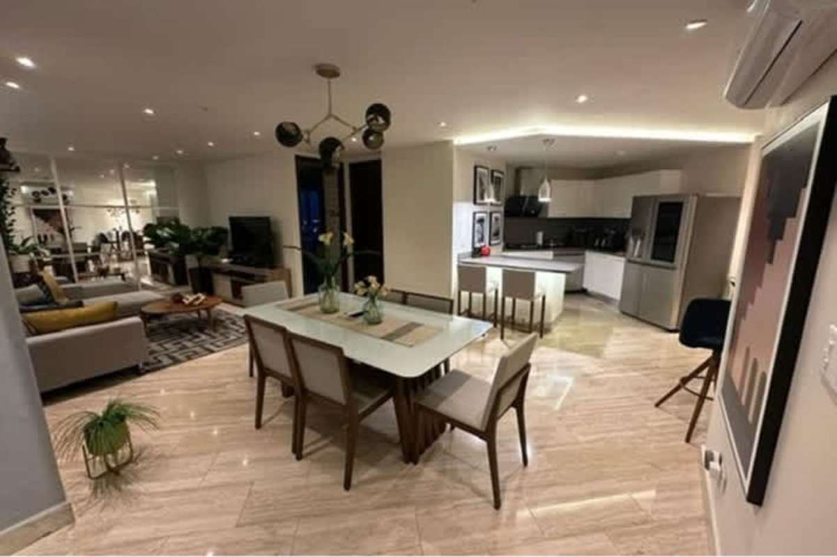 Bright modern living room with floor-to-ceiling windows, marble floors in Costa del Este Panama