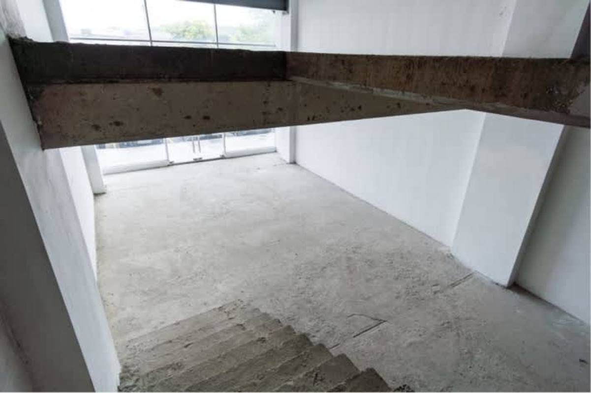 Unfinished commercial interior concrete floors, exposed beam panoramic window Betania PH Panama