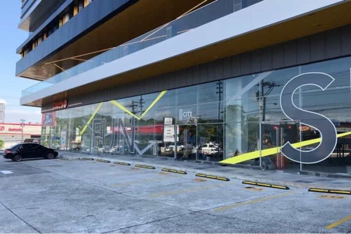 Glass storefront and parking lot outside new retail commercial complex Betania Panama