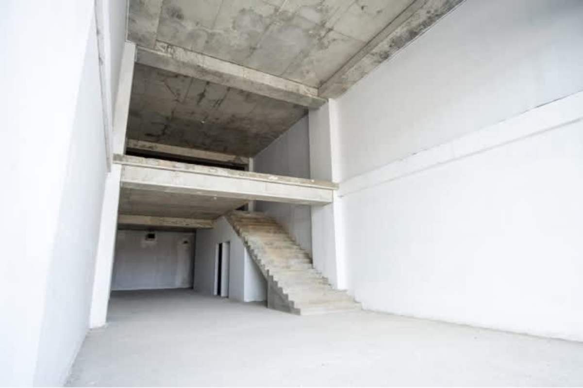 Unfinished industrial commercial loft with concrete staircase and high ceilings for rent in Betania Panama