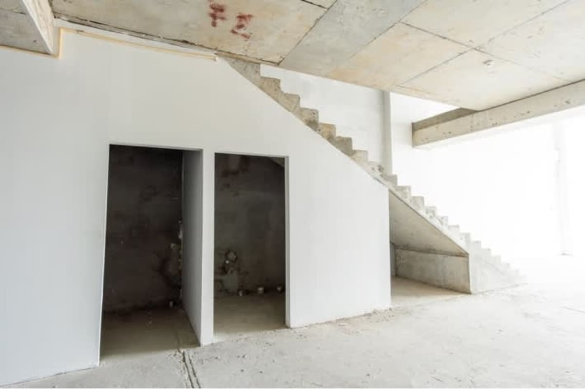 Concrete basement with stairway, open alcoves in commercial plaza Betania Panama