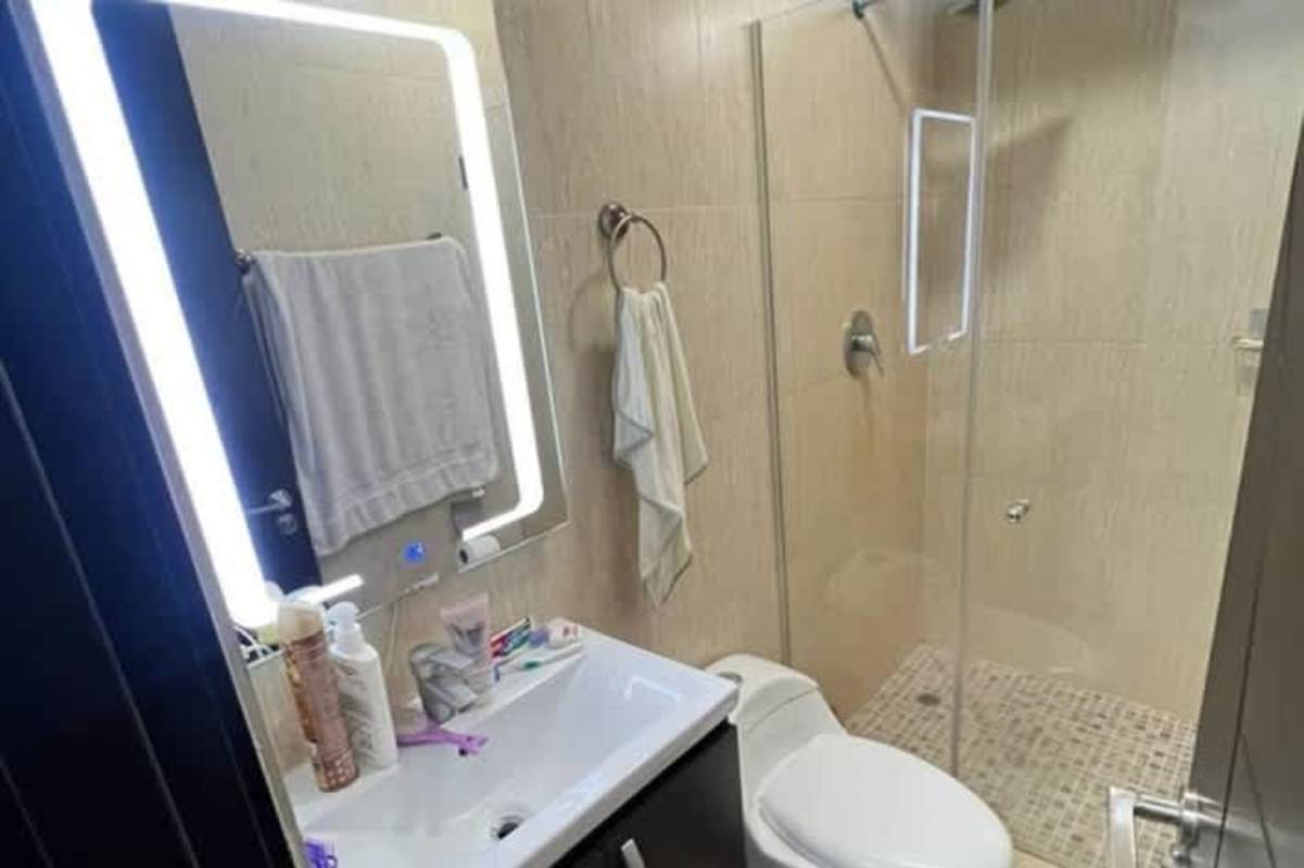 Bathroom with glass shower, illuminated mirror, modern fixtures PH Torres de Carrasquilla Panama